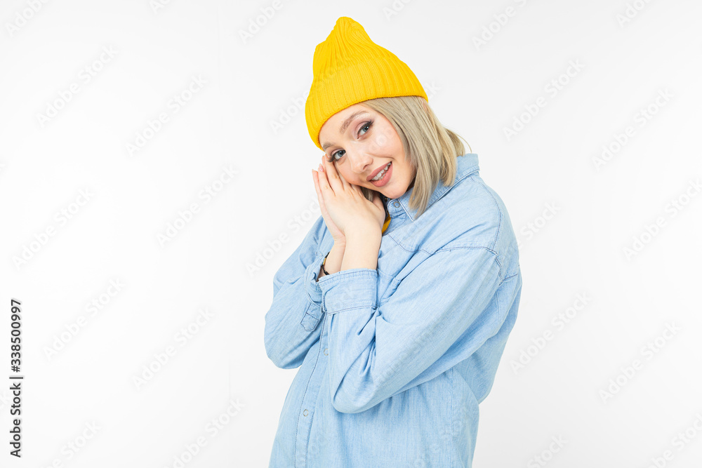 close-up of a charming blond girl in a blue denim jacket on a white background isolated with copy space