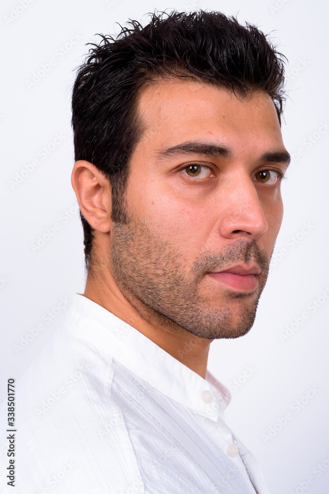Closeup profile view of handsome Turkish man looking at camera Closeup profile view of handsome Turkish man looking at camera