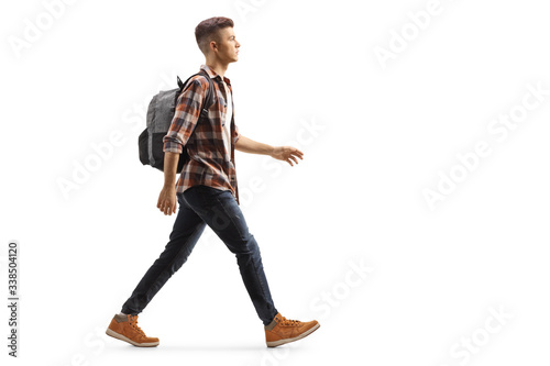 Male student with a backpack walking photo