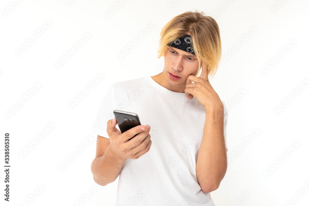 Beautiful young man with mobile phone isolated on white background Beautiful young man with mobile phone isolated on white background