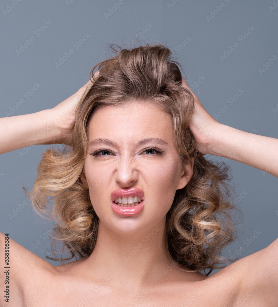 Fototapeta premium Beautiful girl with curly blond hair and flawless skin