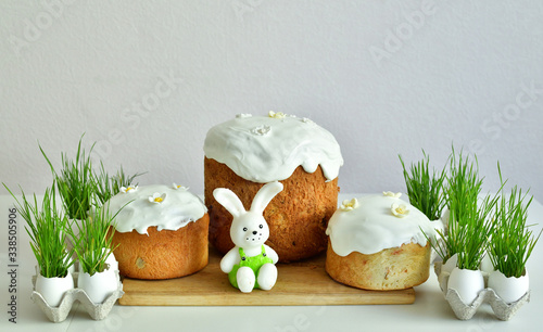 Easter orthodox sweet bread, Easter cake with green grass. Holidays breakfast concept with copy space. Easter greeting card template. Homemade pasques.Easter sweets on white background. photo
