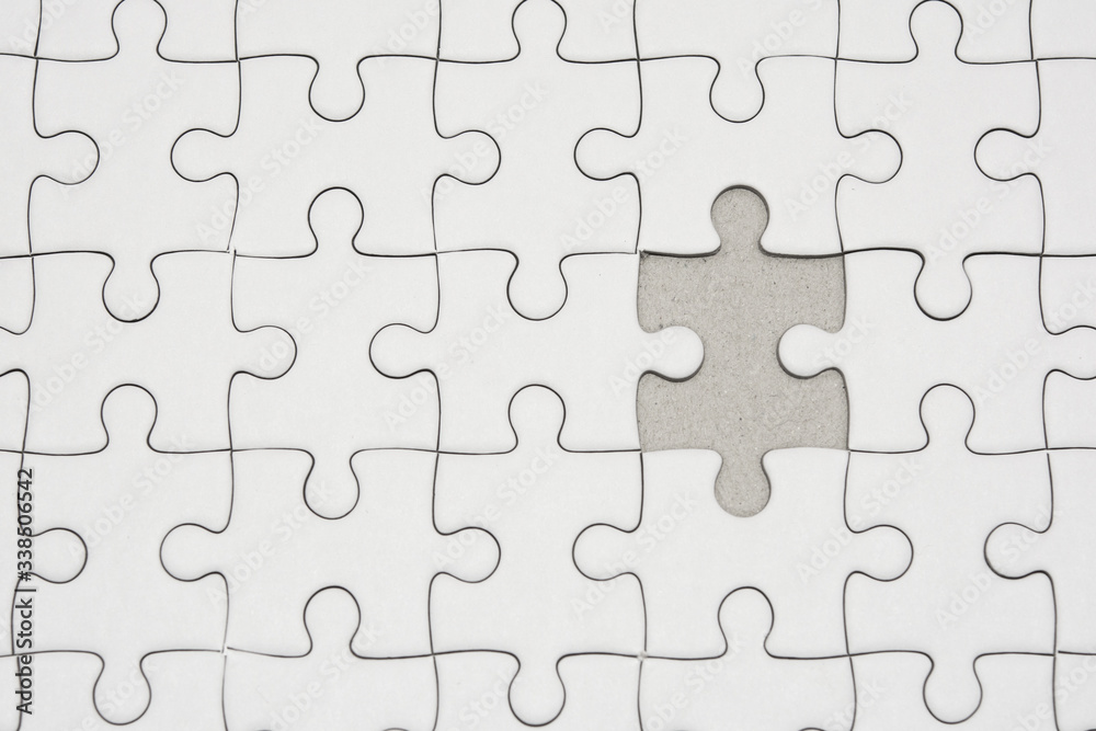 White jigsaw puzzle pattern background. placing last piece of jigsaw puzzle