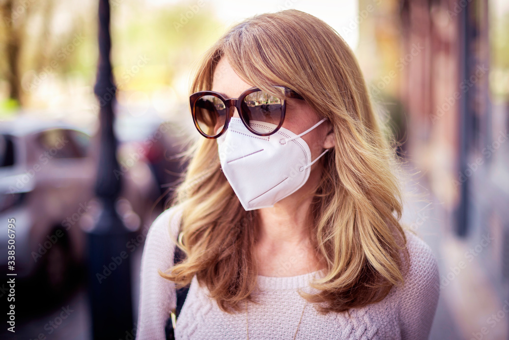 Close-up of mature woman protecting herself with face mask during coronavirus outbreak Close-up of mature woman protecting herself with face mask during coronavirus outbreak