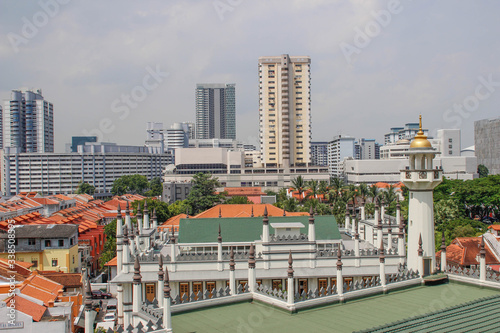 Singapore state and city street with colorful shops, skyscrapers, shops and tourists and locales. Singapore street life and architecture.