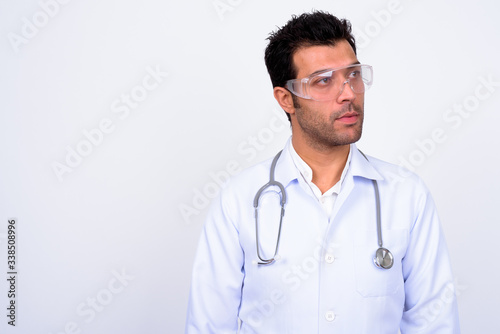 Handsome Turkish man doctor wearing protective glasses against white background