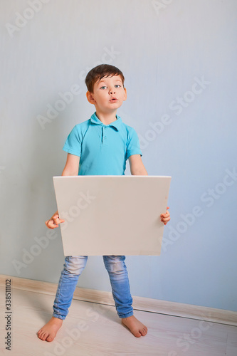 A boy with a sign on a blue background. place for the label