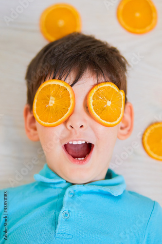 Boy with oranges on a blue background