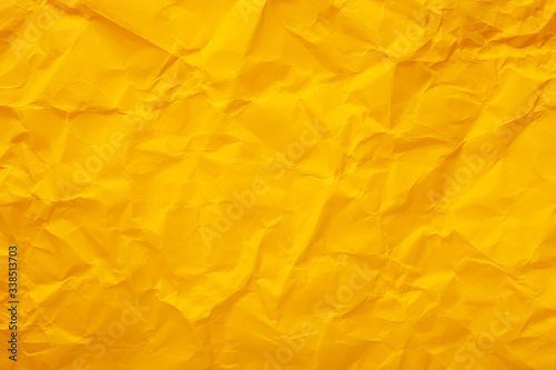 Yellow crumpled paper texture as background. Copy space text