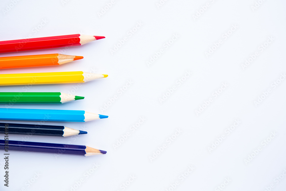 set of colored pencils on a white background with space for text