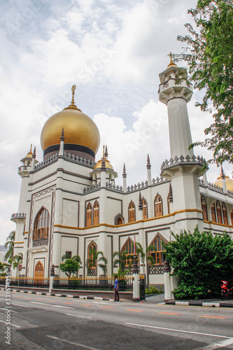 Beautiful Sultan Mosque or Masjid Sultan Mosque in Singapore in the Arab quarter with a golden dome and beautifully decorated white walls.