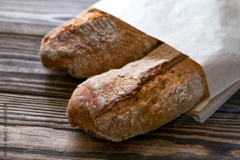 Brouwn baguettes  on wooden background. French bread.