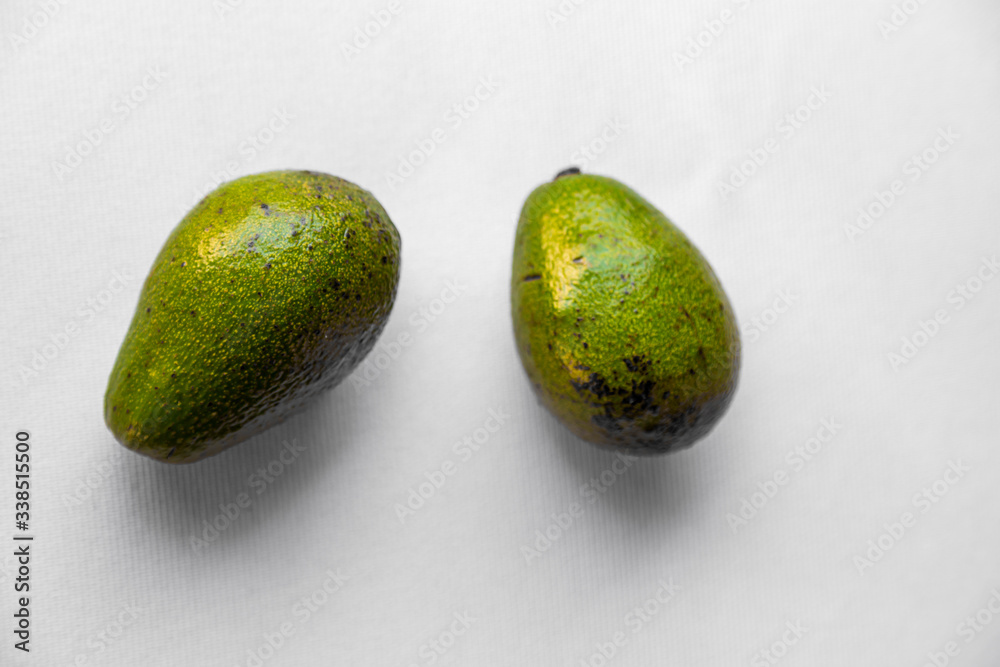 Avocado on white background, vegetarian food, mexican food, tropical fruit for breakfast, copy space. 