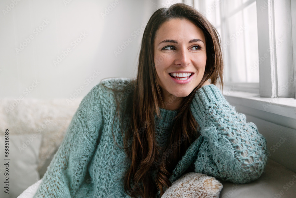 Candid lifestyle head shot of beautiful young woman smiling at home, perfect straight white teeth and cheerful expression Candid lifestyle head shot of beautiful young woman smiling at home, perfect straight white teeth and cheerful expression