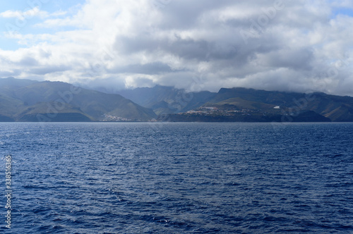 Fototapeta Naklejka Na Ścianę i Meble -  Magnificent views from the high seas with a beautiful enraged sky as a background the island of La Gomera. April 15, 2019. La Gomera, Spain Africa. Travel Tourism Photography Nature.