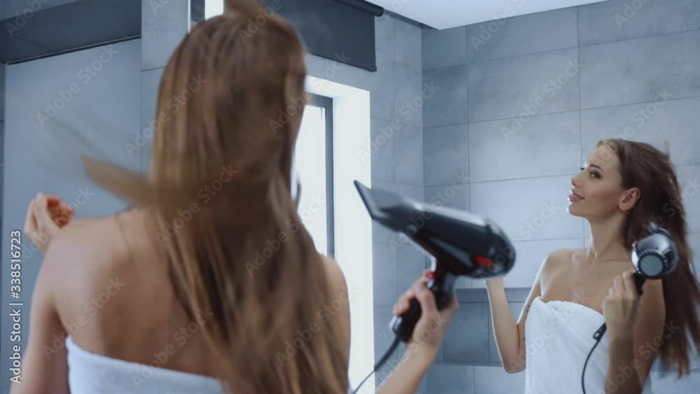 beautiful young woman in bath towel drying hair in bathroom beautiful young woman in bath towel drying hair in bathroom
