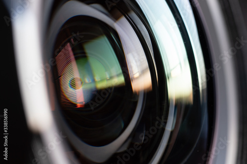 Close-up camera lens with color reflections photo