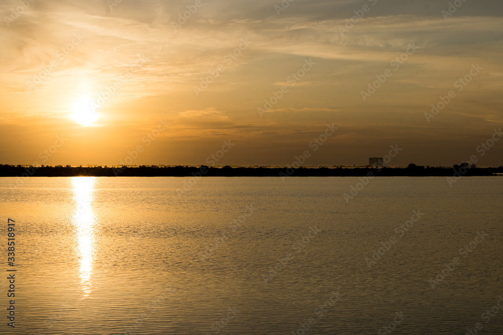 sunrise over lake, launch pad in background, cape canaveral