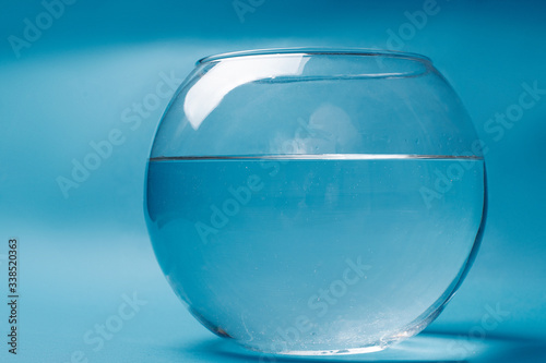  Transparent aquarium with water on a blue background