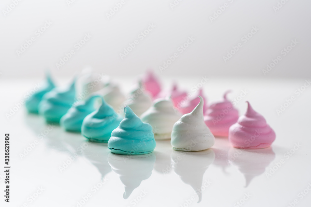 Meringue cookies on a white background. Sweet pastries. Assorted colors
