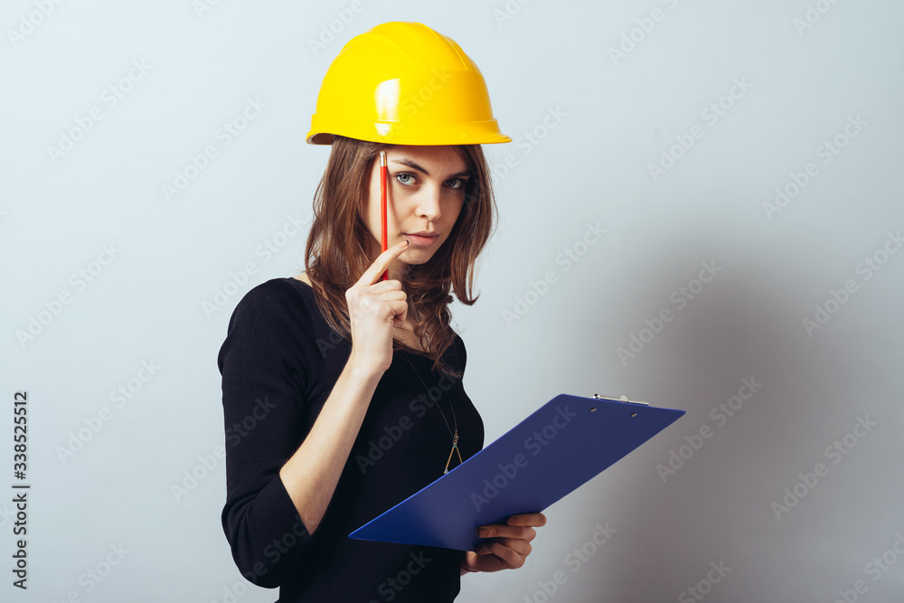 Beautiful young girl in the construction helmet Beautiful young girl in the construction helmet