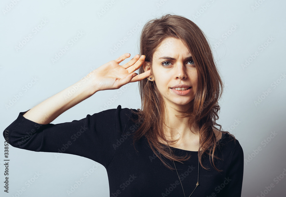 A frustrated pretty woman putting her finger in her ear A frustrated pretty woman putting her finger in her ear