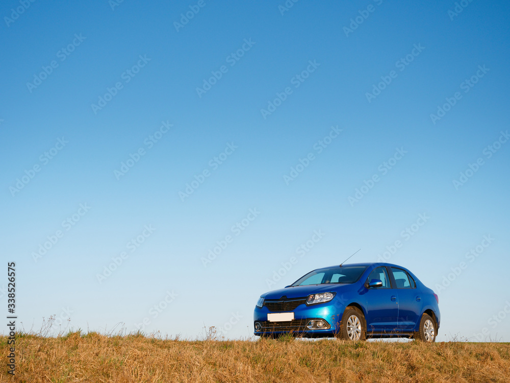 Belarus blue car in a field in spring at sunrise Belarus blue car in a field in spring at sunrise