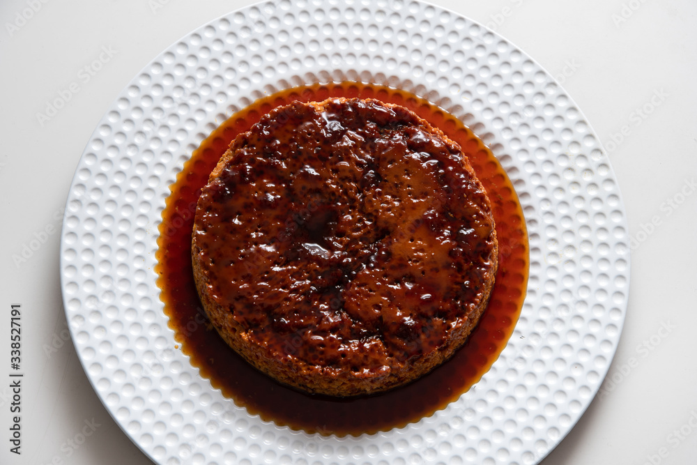 Quesillo Flan Creme Caramel on white plate white background Quesillo Flan Creme Caramel on white plate white background