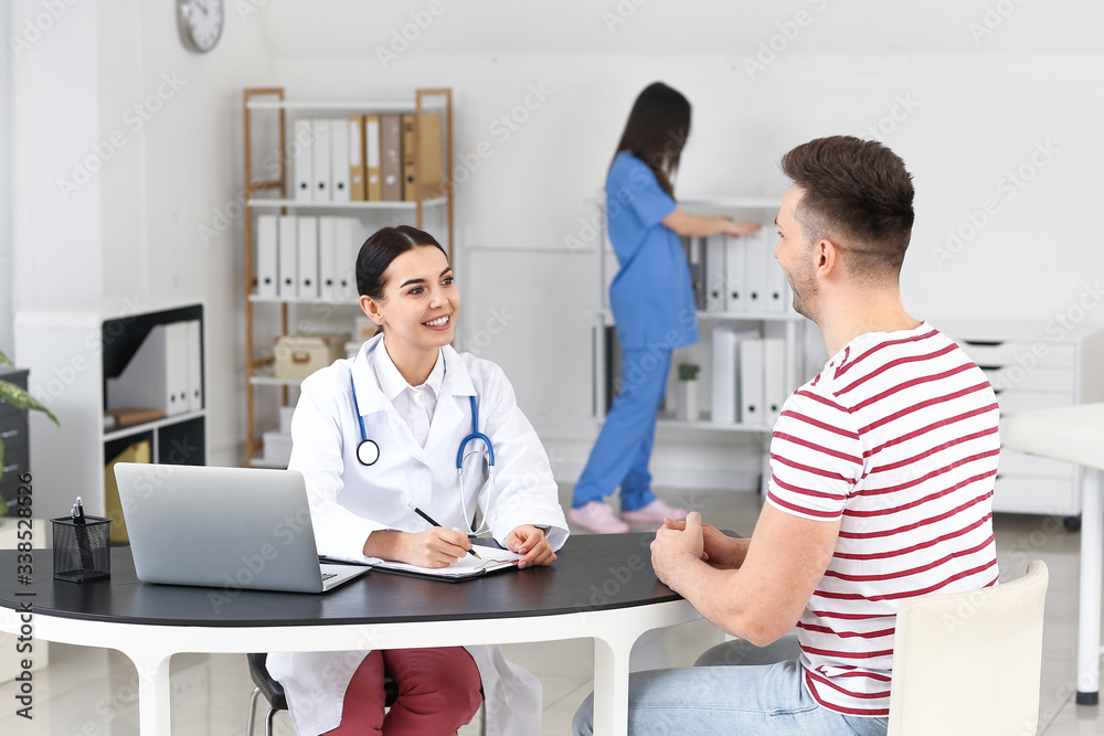 Male patient visiting doctor in clinic Male patient visiting doctor in clinic