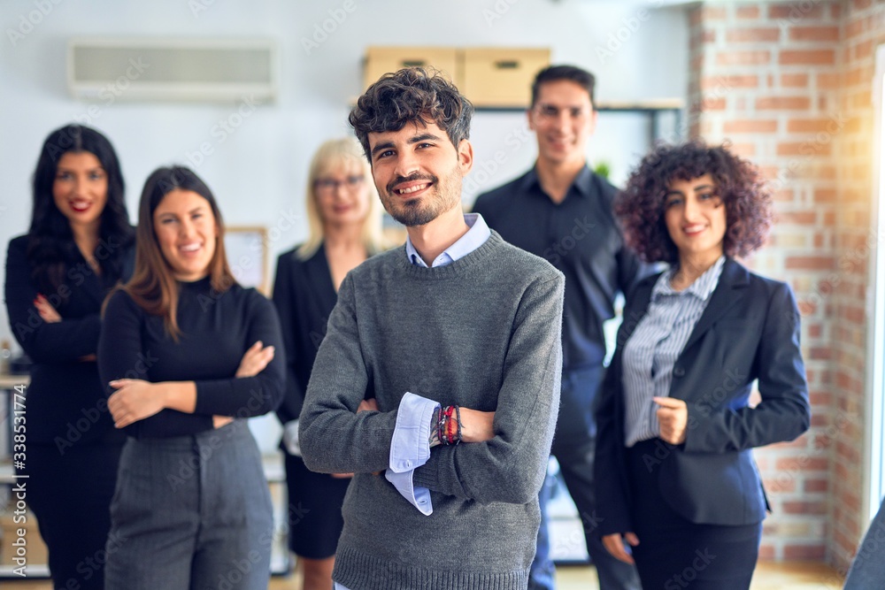 Group of business workers smiling happy and confident. Posing together with smile on face looking at the camera, young handsome man with crossed arms at the office Group of business workers smiling happy and confident. Posing together with smile on face looking at the camera, young handsome man with crossed arms at the office