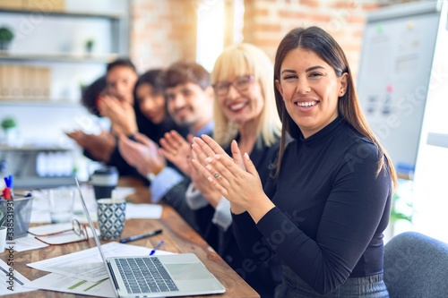 Group of business workers smiling happy and confident. Working together with smile on face looking at the camera applauding at the office