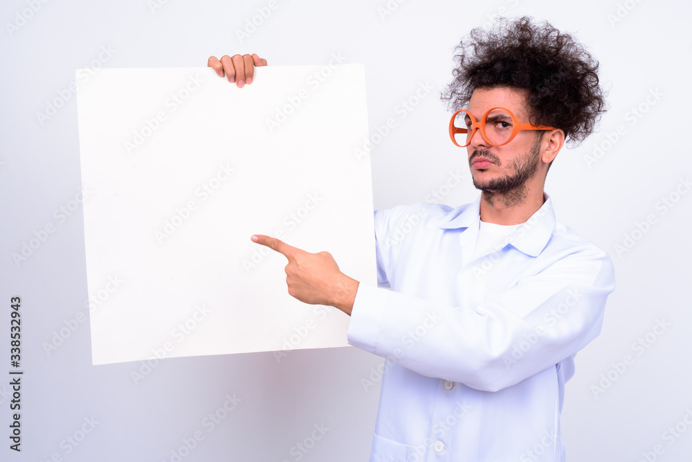Handsome Turkish man doctor with curly hair against white background Handsome Turkish man doctor with curly hair against white background