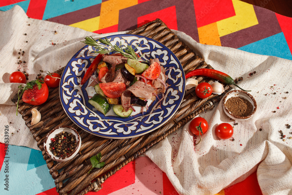 Fototapeta premium Dishes of Uzbek cuisine on a red background and beautiful decoration.