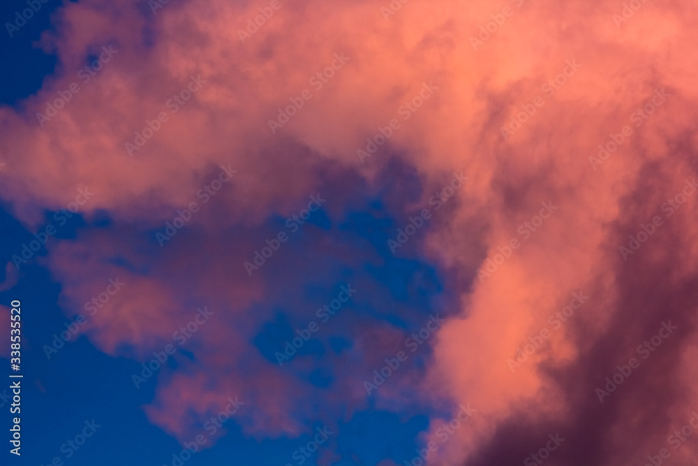 pink clouds on a background of blue sky at sunset