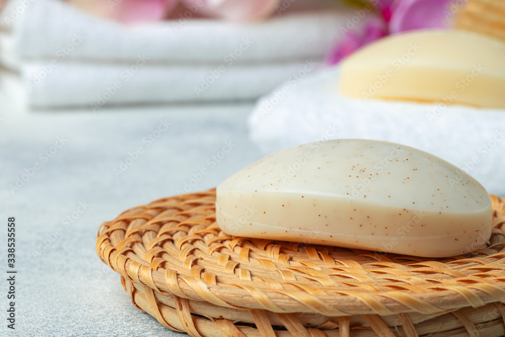 Bar of natural handmade soap, towel and spa objects, close up Bar of natural handmade soap, towel and spa objects, close up