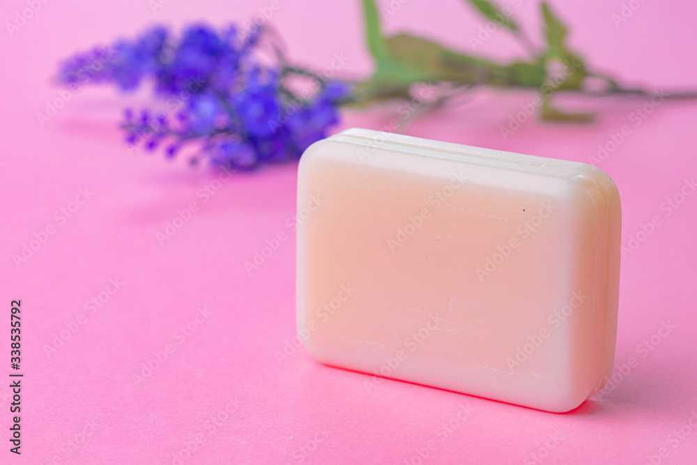 Bars of handmade soap with flowers on the table, close up Bars of handmade soap with flowers on the table, close up