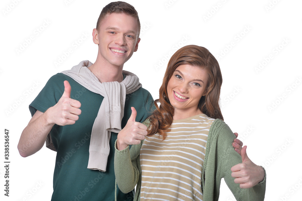 Beautiful woman and man showing thumbs up isolated on white Beautiful woman and man showing thumbs up isolated on white