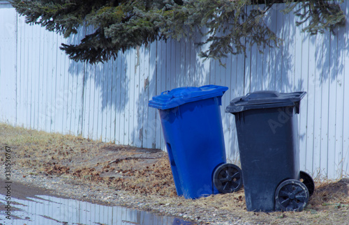 Canvas Print A recycling and garbage bin put out in a back alley awaiting pickup