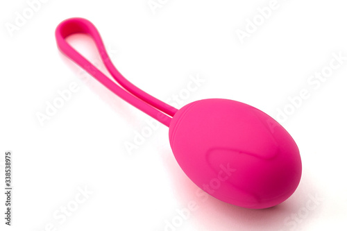 Metaphor for pelvic floor exercise and intimate health for better sexual performance concept with close up on one single pink kegel weight isolated on white background with clipping path cutout photo