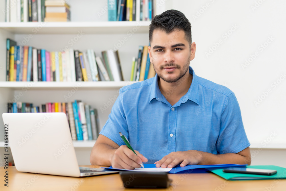 Hispanic hipster man stay at home and working at home office Hispanic hipster man stay at home and working at home office