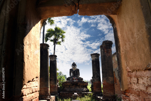 Old sitting Buddha statue in ruined temple, Yadana Hsemee Pagoda is a pagoda complex in the ancient capital of Inwa (Ava), Mandalay, Myanmar (Burma) photo