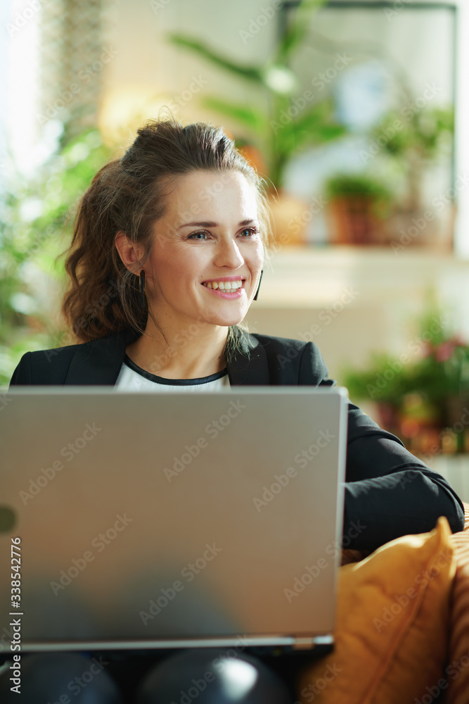 happy modern woman and surfing web while sitting on couch happy modern woman and surfing web while sitting on couch
