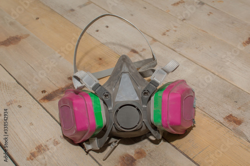 A professional respirator mask set upon a barn wood background. photo