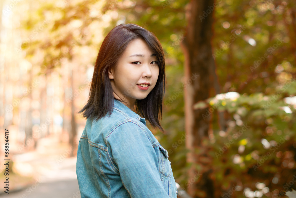 Portrait of a beautiful Asian young girl in nature. Copy space. Portrait of a beautiful Asian young girl in nature. Copy space.