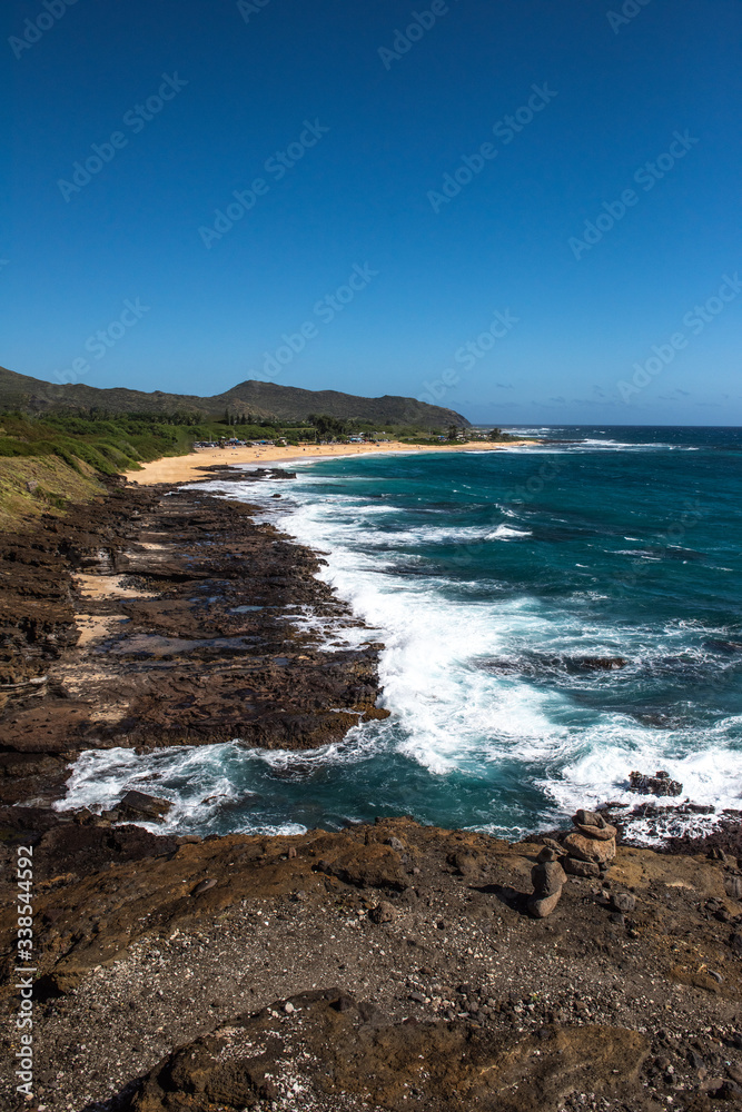 Rock And Sand Beach With Breaking Waves
