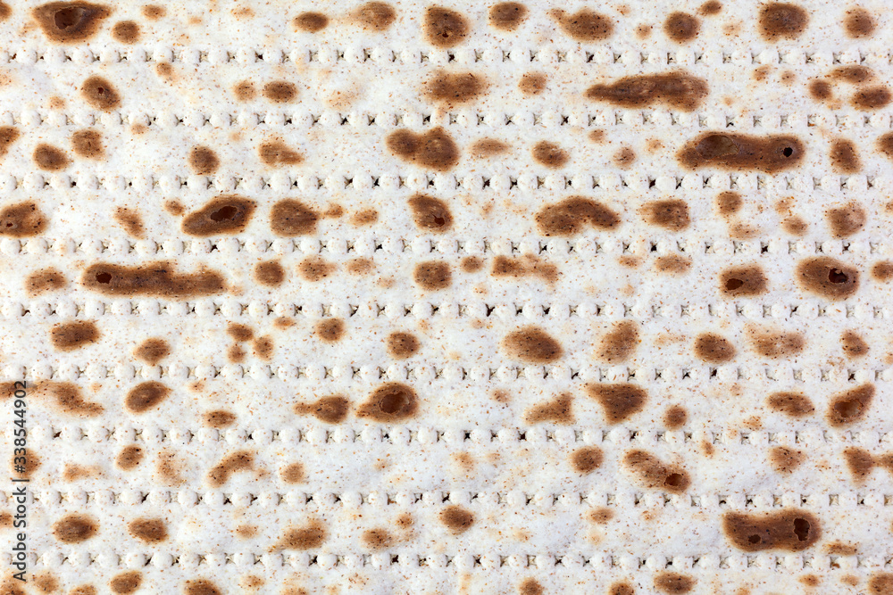 Matzah. Jewish traditional Passover bread. Pesach celebration symbol. With some free space for your text or sign . Close-up. Matzah. Jewish traditional Passover bread. Pesach celebration symbol. With some free space for your text or sign . Close-up.
