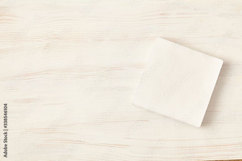 White tissue paper on wooden table. Top view. White tissue paper on wooden table. Top view.
