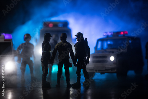 Police cars at night. Police car chasing a car at night with fog background. 911 Emergency response police car speeding to scene of crime. Selective focus © zef art