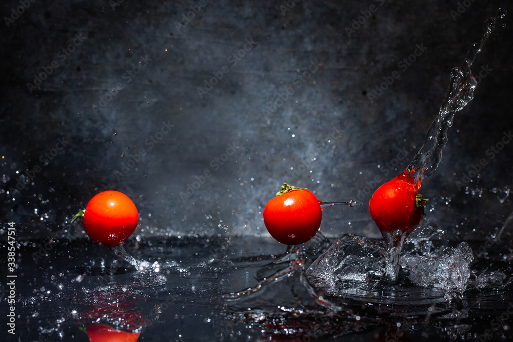 Red tomatoes washed in water drops