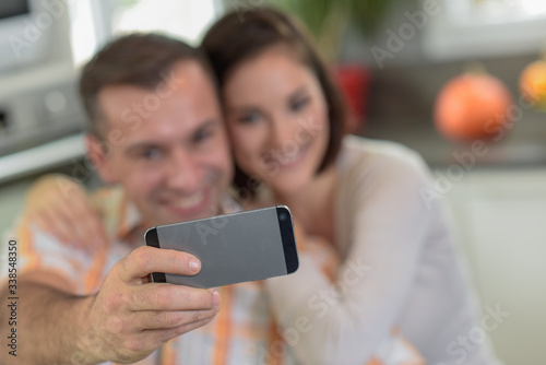 Young couple doing a selfie in the kitchen photo